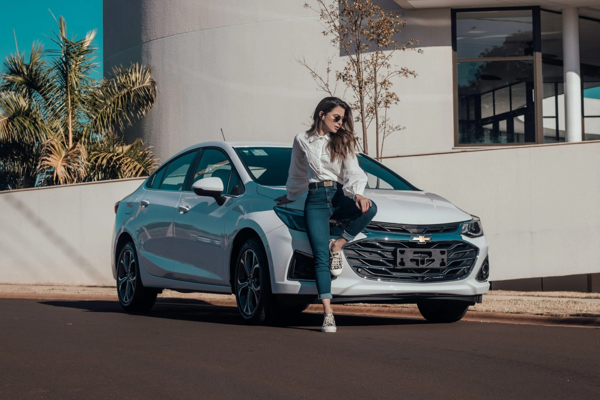raphael-lovaski-GIGXTbZ_VPY-unsplash-scaled-2048x1366 white car and a lady sitting on the hood