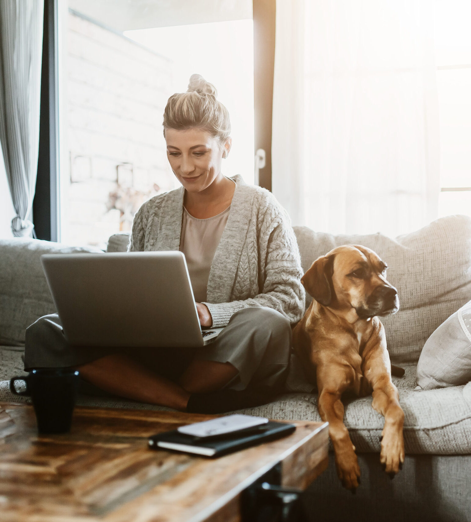 Businesswoman working on laptop computer sitting at home with a